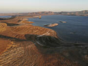 FILE - Water levels are low at San Luis Reservoir, which stores irrigation water for San Joaquin Valley farms, Sept. 14, 2022, in Gustine, Calif. California Gov. Gavin Newsom announced an end to some drought restrictions and calls for water conservation on Friday, March 24, 2023, following a series of winter storms have dramatically improved the state's water supply outlook.