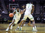 Oregon guard Jermaine Couisnard (5) moves around a screen by center N'Faly Dante (1) on California forward Grant Newell (14) during the first half of an NCAA college basketball game Thursday, March 2, 2023, in Eugene, Ore.