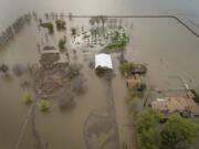 An expansive home along 6th Avenue sits in rising floodwaters after levee breaks caused extensive flooding around Corcoran, Calif., on Tuesday, March 21, 2023. Flooding in the lower Central Valley of California has brought back a long-unseen seasonal body of water, Tulare Lake.