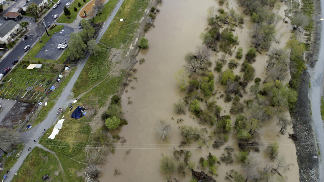 This photo provided by the California Strawberry Commission shows a flooded Pajaro River in Pajaro, Calif. on Tuesday, March 14, 2023. California's strawberry farms have been hit hard by this year's winter storms. Industry experts estimate about a fifth of strawberry farms in the Watsonville and Salinas areas have been flooded since a levee ruptured last week and another river overflowed.