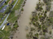 This photo provided by the California Strawberry Commission shows a flooded Pajaro River in Pajaro, Calif. on Tuesday, March 14, 2023. California's strawberry farms have been hit hard by this year's winter storms. Industry experts estimate about a fifth of strawberry farms in the Watsonville and Salinas areas have been flooded since a levee ruptured last week and another river overflowed.