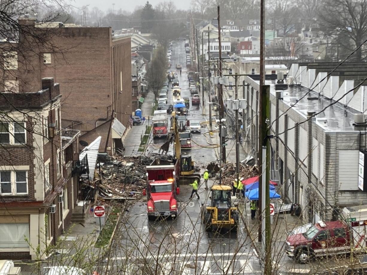 Emergency responders and heavy equipment are seen at the site of a deadly explosion at a chocolate factory in West Reading, Pennsylvania, Saturday, March 25.