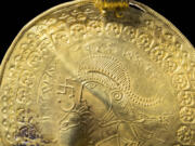 The inscription 'He is Odin's man' is seen in a round half circle over the head of a figure on a golden bracteate unearthed in Vindelev, Denmark in late 2020. Scientists have identified the oldest-known reference to the Norse god Odin on a gold disc unearthed in western Denmark.