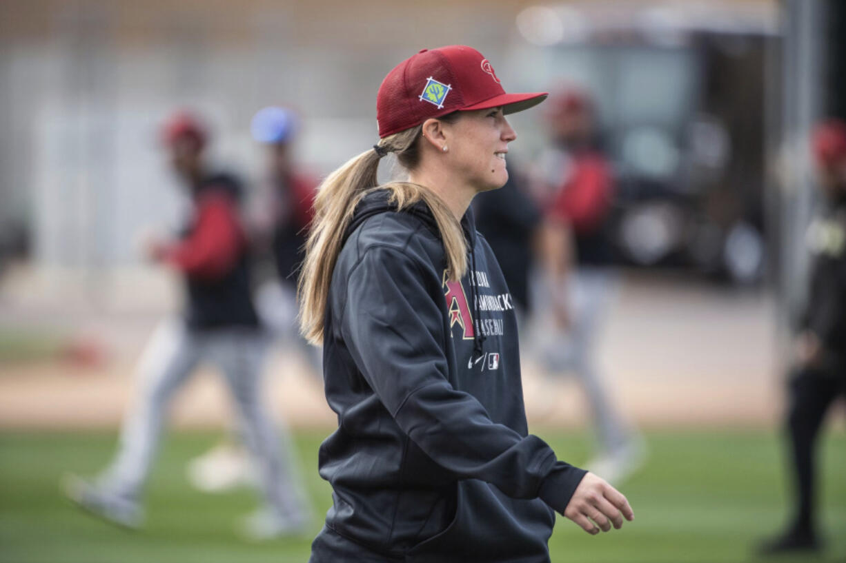 FILE - In a photo provided by the Arizona Diamondbacks, Ronnie Gajownik watches the baseball team's minor league minicamp at Salt River Fields in February 2022 in Scottsdale, Ariz. As Gajownik prepares for her first managing job in the minor leagues, took on a temporary role Saturday, March 4 -- bench coach for the Arizona Diamondbacks. D-backs manager Torey Lovullo confirmed Gajownik's spot before the spring training game against San Diego.