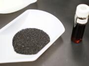 A sample of granular activated carbon, used to remove PFAS from water, sits on display during a tour of the U.S. Environmental Protection Agency Center For Environmental Solutions and Emergency Response, Tuesday, Feb. 14, 2023, in Cincinnati. The Environmental Protection Agency is expected to propose restrictions on harmful "forever chemicals" in drinking water after finding they are dangerous in amounts so small as to be undetectable, but experts say removing them will cost billions. (AP Photo/Joshua A.