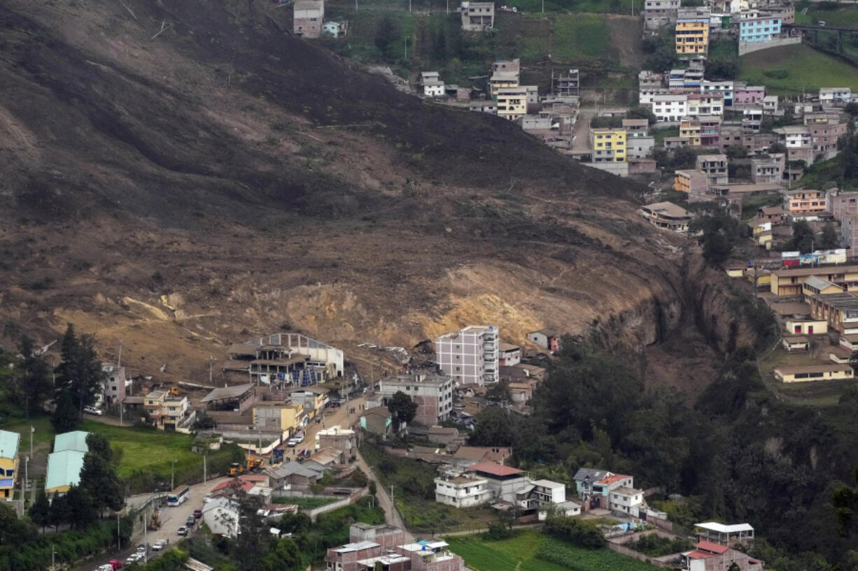 Some homes stand after a deadly landslide caused by heavy rains that buried dozens of homes in Alausi, Ecuador, Monday, March 27, 2023.