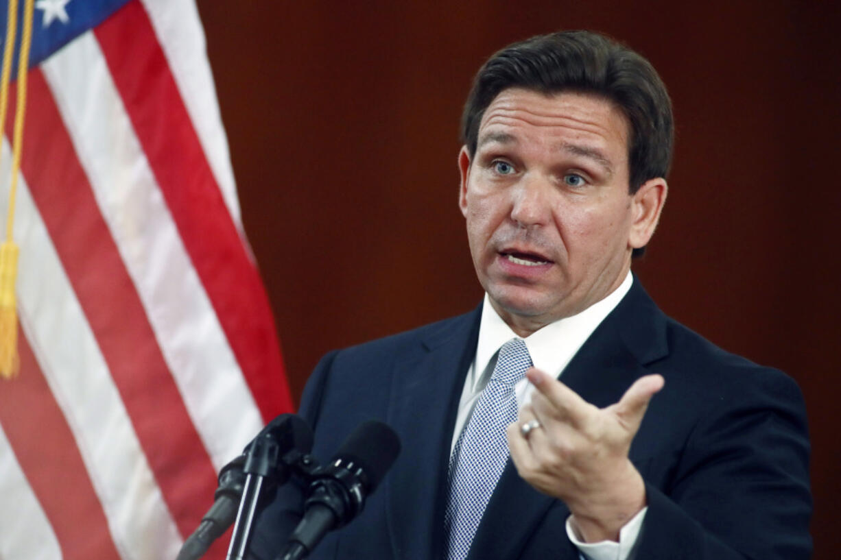 FILE - Florida Gov. Ron DeSantis answers questions from reporters after his State of the State address during a joint session of the Senate and House of Representatives March 7, 2023, at the Capitol in Tallahassee, Fla. DeSantis will be in Iowa on March 10 to introduce himself to an expectant audience of Republicans, making a long-awaited visit ahead of a likely 2024 presidential bid.