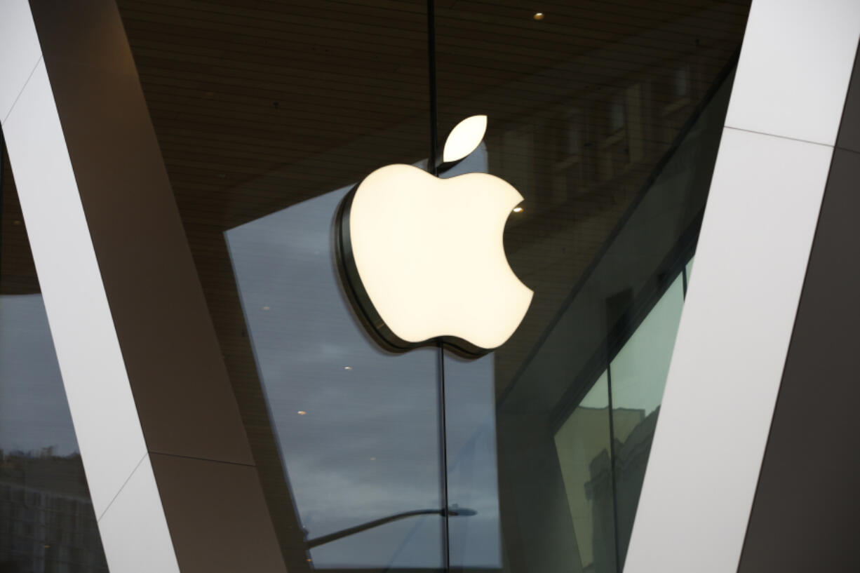 FILE - An Apple logo adorns the facade of the downtown Brooklyn Apple store on March 14, 2020, in New York. Apple is getting into the Buy Now, Pay Later space with a few tweaks to the existing model -- including no option to pay with a credit card. The company will roll out the product to some consumers spring 2023, and will begin reporting the loans to credit bureaus in the fall.