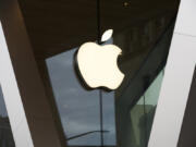 FILE - An Apple logo adorns the facade of the downtown Brooklyn Apple store on March 14, 2020, in New York. Apple is getting into the Buy Now, Pay Later space with a few tweaks to the existing model -- including no option to pay with a credit card. The company will roll out the product to some consumers spring 2023, and will begin reporting the loans to credit bureaus in the fall.