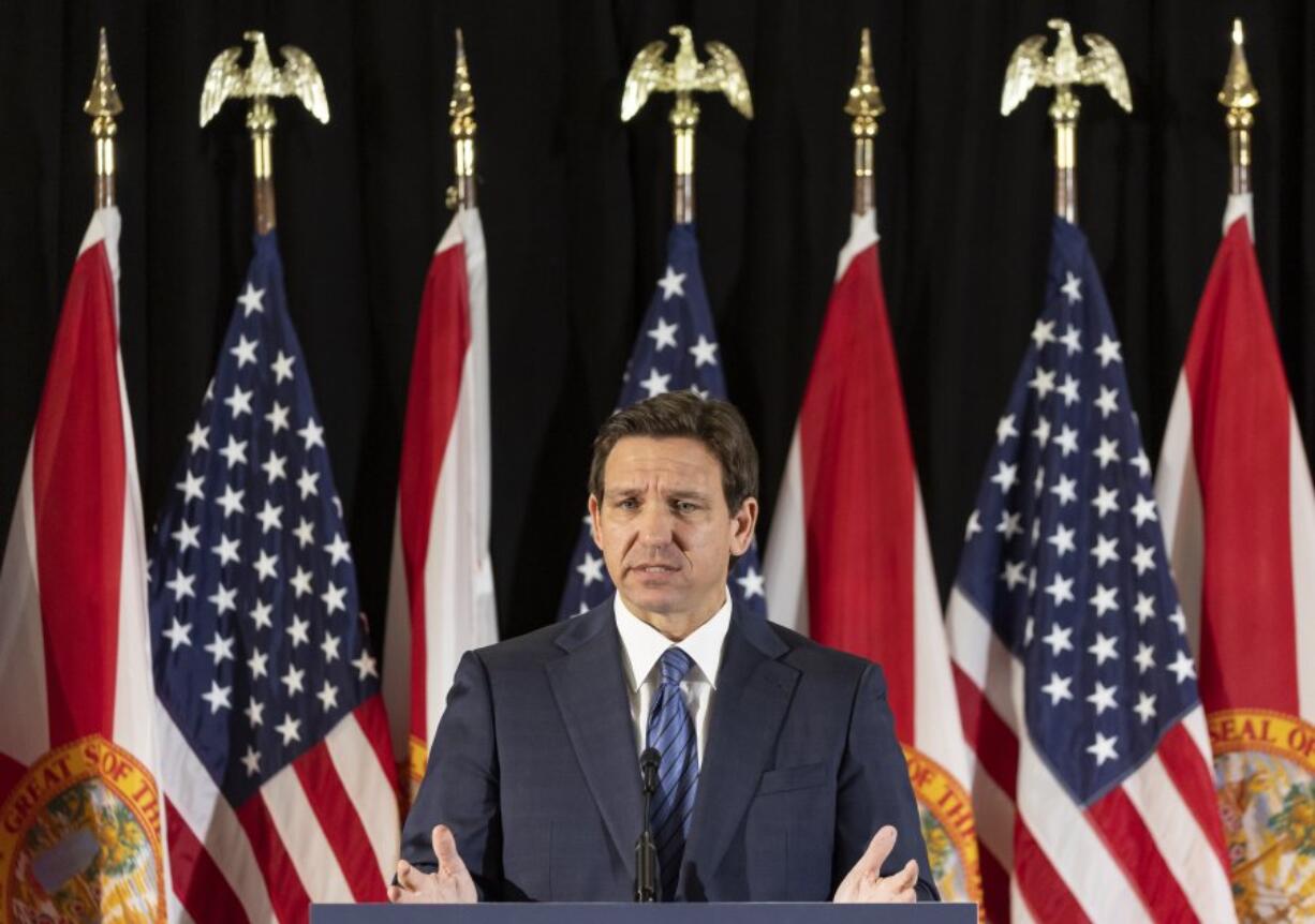 Florida Governor Ron DeSantis answers questions from the media during a press conference at Christopher Columbus High School on Monday, March 27, 2023, in Miami, Fla. The press conference was held to announce DeSantis's signing of a private school voucher expansion, HB1, which allows more Florida school children become eligible for taxpayer-funded school vouchers.(Matias J.