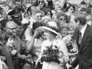 FILE - People gather to greet Britain's Queen Elizabeth II as she walked along the famous Kurfuerstendamm Boulevard in West Berlin, Germany, on May 24, 1978. One would like two horses. That, in effect, was the gift requested by Britain's Queen Elizabeth II during her state visit to Germany in 1978, weekly Der Spiegel reported Monday, March 27, 2023.