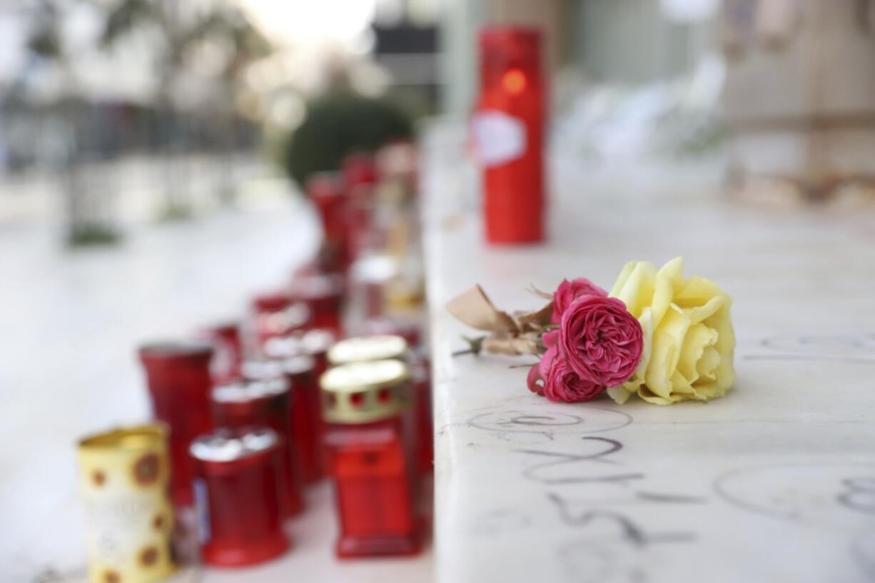 Carnations lie outside a court in Larissa city, about 355 kilometres (222 miles) north of Athens, Greece, Sunday, March 5, 2023. The station master involved in Greece's deadliest train crash is set to appear to a prosecutor and an examining magistrate on Sunday.