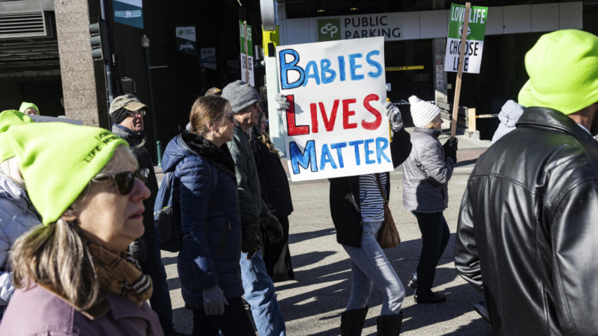 People walk to the Idaho Capitol Building for the Boise March for Life rally on Jan. 21. A rural hospital in Sandpoint, Idaho, will stop delivering babies, citing recently passed state laws criminalizing medical care, among other reasons.