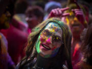 A girl smeared with colors celebrates Holi, the festival of colors on a street in Guwahati, India, Wednesday, March 8, 2023.Millions of Indians on Wednesday celebrated the ''Holi" festival, dancing to the beat of drums and smearing each other with green, yellow and red colors and exchanging sweets in homes, parks and streets. Free from mask and other COVID-19 restrictions after two years, they also drenched each other with colored water.