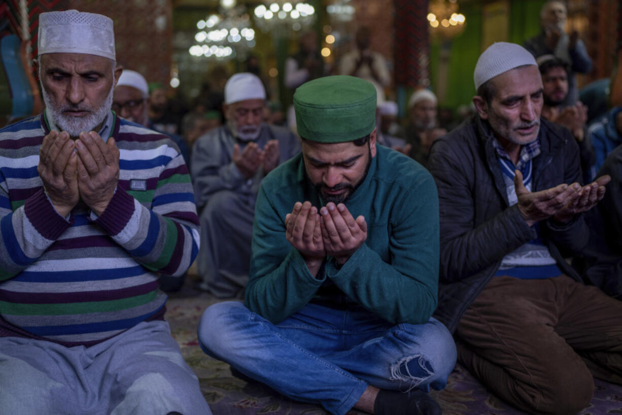 Kashmiri Muslims pray inside the shrine of Sufi saint Shiekh Abdul Qadir Jeelani on the first day of ramadan in Srinagar, Indian controlled Kashmir, Thursday, March 23, 2023. The first daily fast of the Islamic holy month of Ramadan began Thursday, as hundreds of millions of Muslims worldwide enter a four-week period of worship.