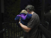 Andrew Hackney hands his 1-year-old daughter back to the Office of Children, Youth and Families services at the end of one of their twice weekly supervised visits in Oakdale, Pa., on Thursday, Nov. 17, 2022. At 7 months old, Andrew and his wife, Lauren, had difficulty feeding their daughter and brought her to the children's hospital in Pittsburgh. They believe hospital staff alerted the Allegheny County Department of Human Services because the baby was severely dehydrated and malnourished, which resulted in removing the young child from their custody. The Hackneys and their lawyer believe the Allegheny County Family Screening artificial intelligence tool may have flagged the couple as dangerous because of their disabilities.