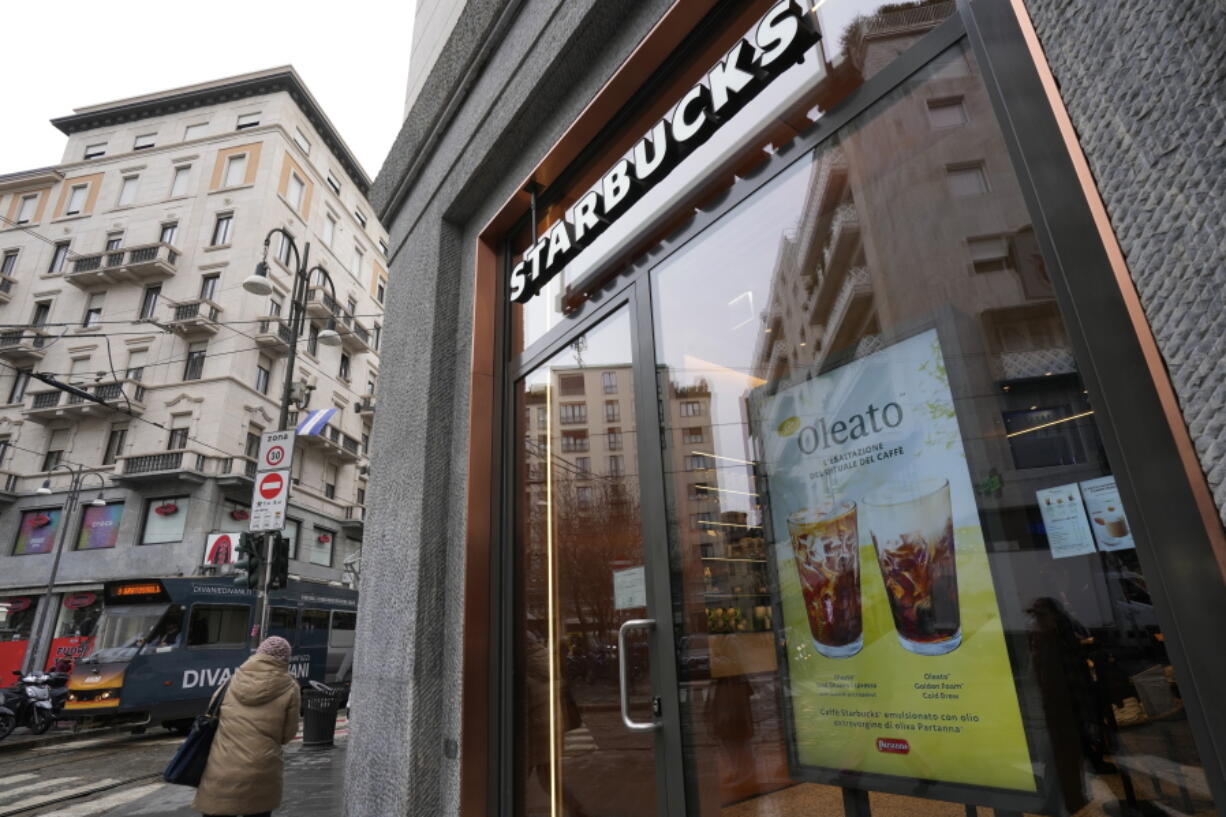 A Starbucks sign advertises the company's Oleato coffee in one of their coffee shops in Milan, Italy, Monday, Feb. 27, 2023. Putting olive oil in coffee is hardly a tradition in Italy, but that didn't stop Starbucks founder and CEO Howard Schultz from launching a series of beverages doing just that in Milan, the city that inspired his coffee house empire.