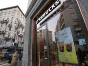 A Starbucks sign advertises the company's Oleato coffee in one of their coffee shops in Milan, Italy, Monday, Feb. 27, 2023. Putting olive oil in coffee is hardly a tradition in Italy, but that didn't stop Starbucks founder and CEO Howard Schultz from launching a series of beverages doing just that in Milan, the city that inspired his coffee house empire.