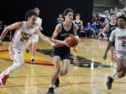 King’s Way Christian’s Giovanny Evanson drives past a King’s defender during the first half of a Class 1A boys basketball state tournament game on Wednesday, March 1, 2023 in Yakima.