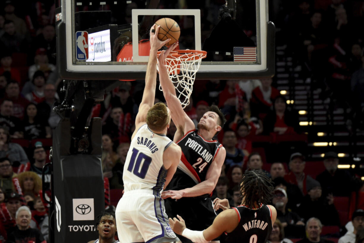 Sacramento Kings forward Domantas Sabonis dunks against Portland Trail Blazers forward Drew Eubanks, right, during the second half of an NBA basketball game in Portland, Ore., Friday, March 31, 2023. The Kings won 138-114.