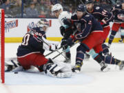 Seattle Kraken's Alex Wennberg (21) scores against Columbus Blue Jackets' Elvis Merzlikins, left, as Andrew Peeke, right front, defends during the third period of an NHL hockey game Friday, March 3, 2023, in Columbus, Ohio.