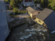 FILE - A house sits in Rock Creek after floodwaters washed away a road and a bridge in Red Lodge, Mont., Wednesday, June 15, 2022. After three nasty years, the La Nina weather phenomenon is gone, the National Oceanic and Atmospheric Administration said Thursday, March 9, 2023.