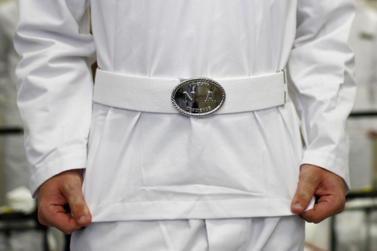 FILE - An Incoming plebe adjusts their uniform during Induction Day at the U.S. Naval Academy, June 27, 2019, in Annapolis, Md. Reported sexual assaults at the U.S. military academies shot up during the 2021-22 school year, and one in five female students surveyed said they experienced unwanted sexual contact, the Associated Press has learned.