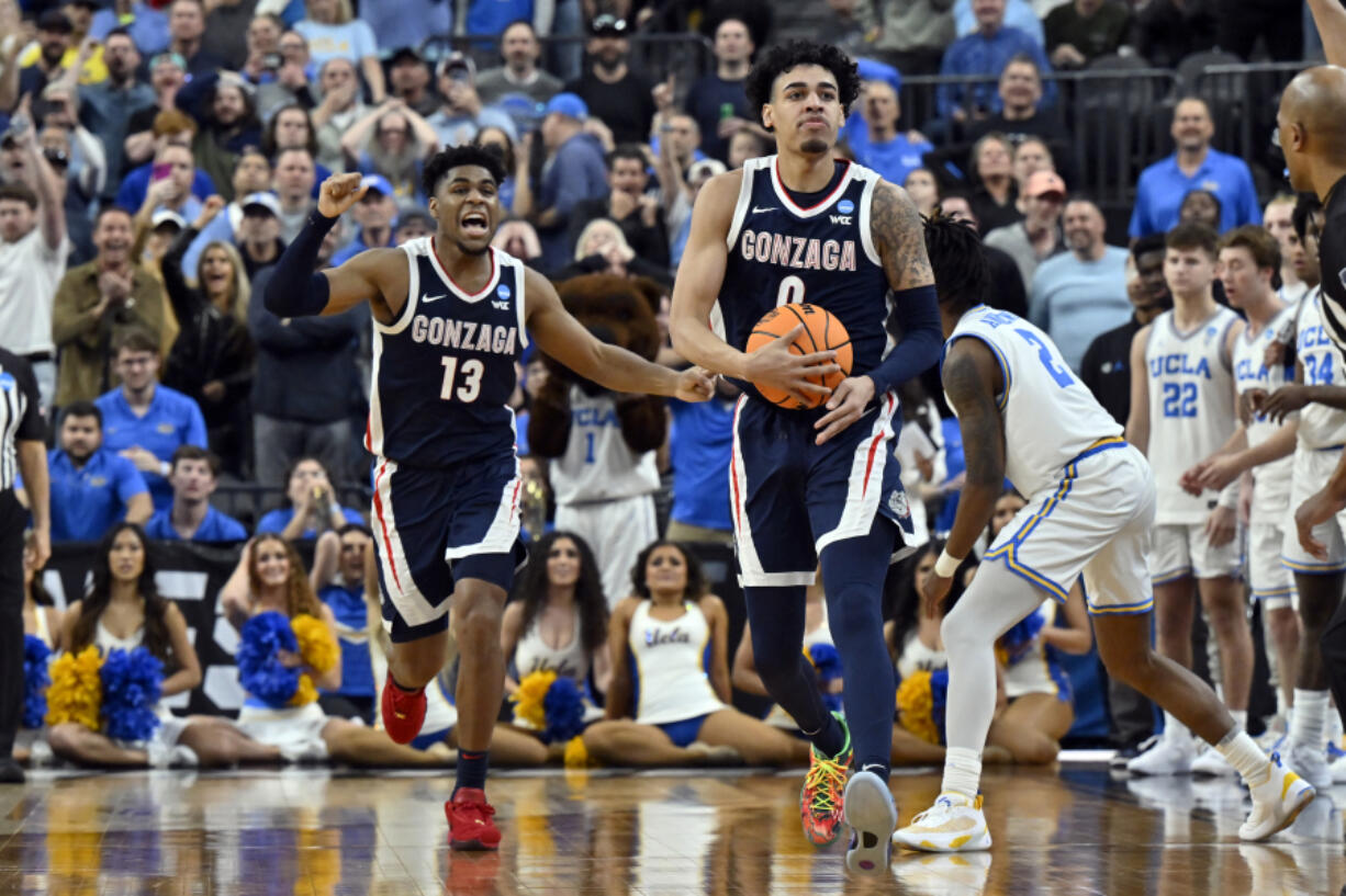 Gonzaga's Julian Strawther, right, and Malachi Smith (13) celebrate in final seconds of the the second half of a Sweet 16 college basketball game against UCLA in the West Regional of the NCAA Tournament, Thursday, March 23, 2023, in Las Vegas.