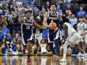 Gonzaga's Julian Strawther, right, and Malachi Smith (13) celebrate in final seconds of the the second half of a Sweet 16 college basketball game against UCLA in the West Regional of the NCAA Tournament, Thursday, March 23, 2023, in Las Vegas.