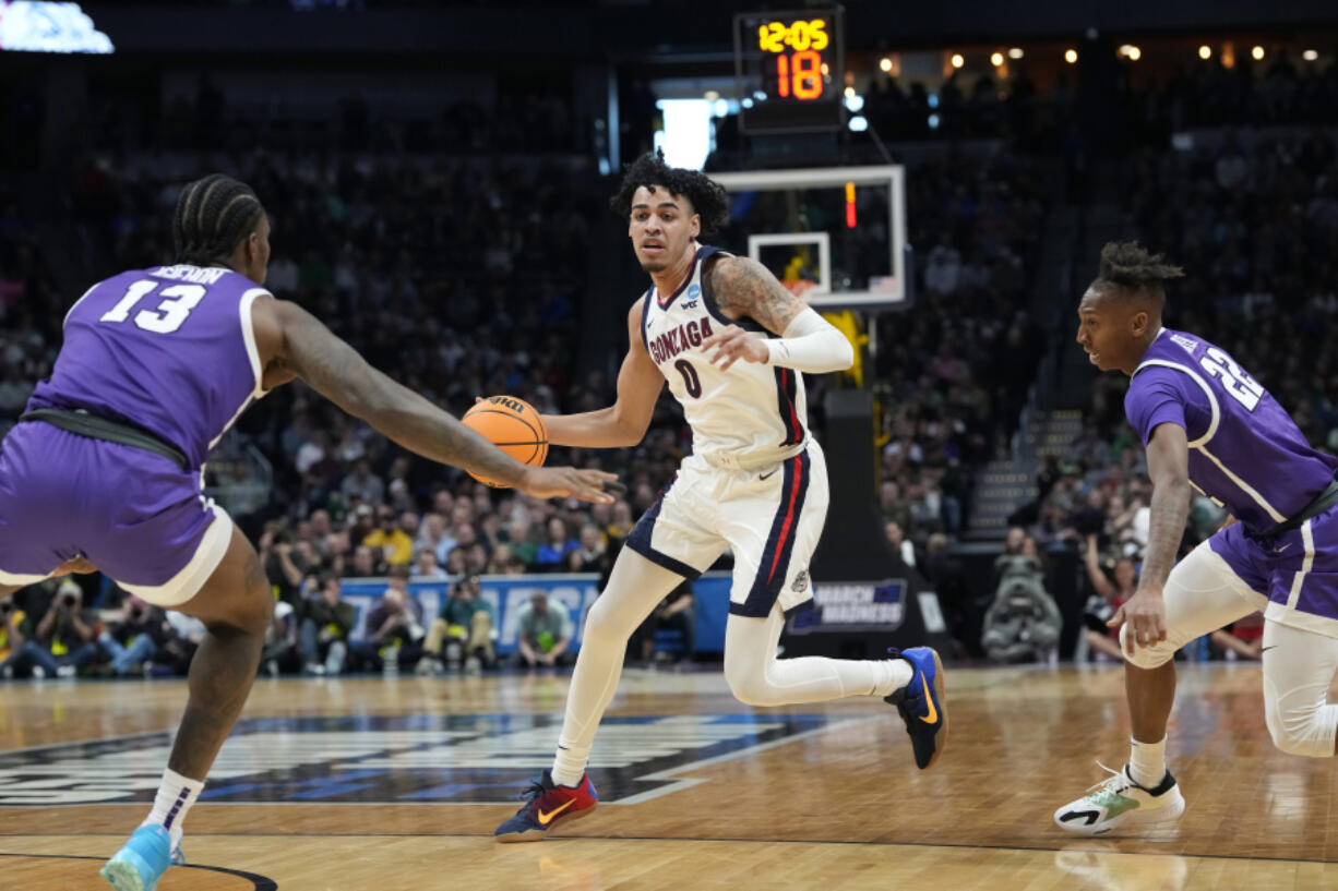 Gonzaga guard Julian Strawther, center, drives between Grand Canyon forward Aidan Igiehon, left, and guard Josh Baker during the first half of a first-round college basketball game in the men's NCAA Tournament on Friday, March 17, 2023, in Denver.