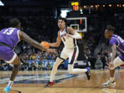 Gonzaga guard Julian Strawther, center, drives between Grand Canyon forward Aidan Igiehon, left, and guard Josh Baker during the first half of a first-round college basketball game in the men's NCAA Tournament on Friday, March 17, 2023, in Denver.