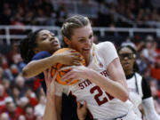 Mississippi guard Angel Baker, left, and Stanford forward Cameron Brink, right, vie for the ball during the first half of a second-round college basketball game in the women's NCAA Tournament, Sunday, March 19, 2023, in Stanford, Calif.