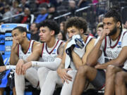 Gonzaga players react from the bench in the second half of an Elite 8 college basketball game against UConn in the West Region final of the NCAA Tournament, Saturday, March 25, 2023, in Las Vegas.