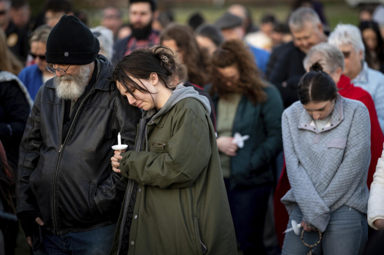 People pray during a community vigil held for the people killed during the Covenant School shooting on Tuesday, March 28, 2023, in Mt. Juliet, Tenn.