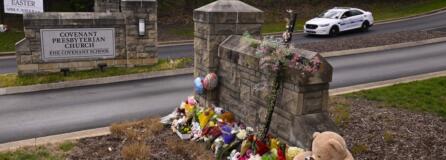 A make shift memorial is seen at the entry to Covenant School with a police car guarding, on Tuesday, March 28, 2023, in Nashville, Tenn. The former student who shot through the doors of the Christian elementary school and killed three children and three adults had drawn a detailed map of the school.