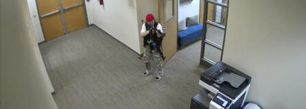 In this screen grab from surveillance video tweeted by the Metropolitan Nashville Police Department, Audrey Elizabeth Hale points an assault-style weapon inside The Covenant School in Nashville, Tenn., Monday, March 27, 2023. The former student shot through the doors of the Christian elementary school and killed several children and adults before being killed by police.