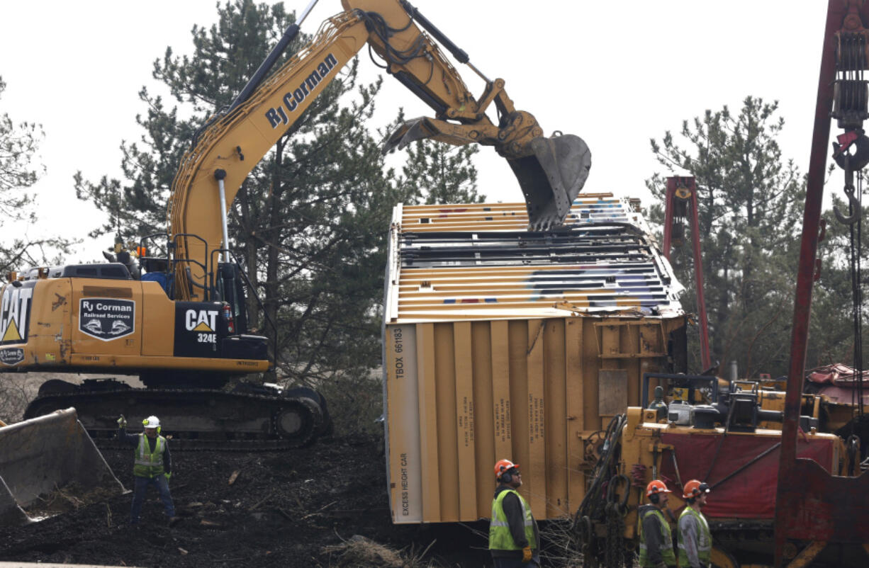 Work crews clean up the derailment of a Norfolk Southern cargo train in Clark County, Ohio, Sunday, March 5, 2023.