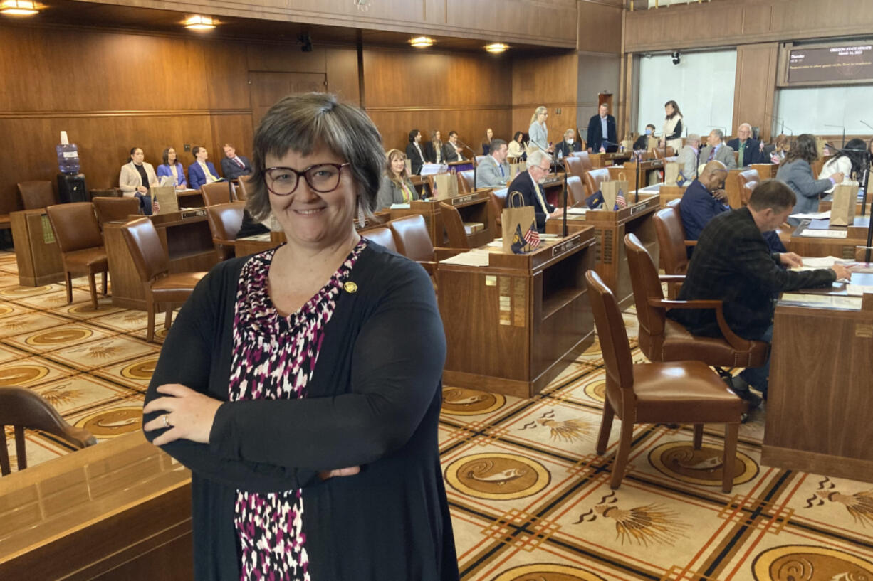 State Sen. Janeen Sollman, a Democrat from Hillsboro, poses on the Senate floor in the Oregon State Capitol in Salem, Ore., on March 16, 2023. Sollman is a chief sponsor of a bill in the Legislature aimed at attracting more of the semiconductor industry to Oregon. One of the provisions would allow the governor to expand a limited number of urban growth boundaries to provide land for the industry, sparking concern among farmers and conservationists.