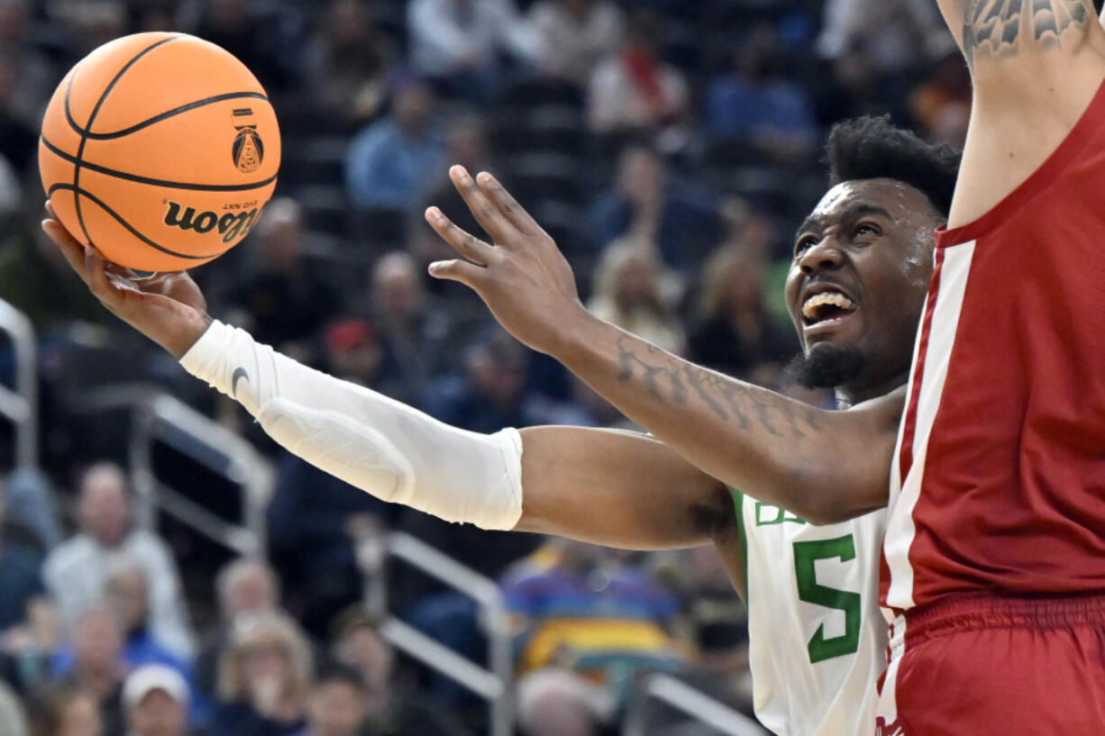 Oregon guard Jermaine Couisnard (5) drives to the basket against Washington State during the second half of an NCAA college basketball game in the quarterfinals of the Pac-12 men's tournament Thursday, March 9, 2023, in Las Vegas.