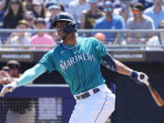 Seattle Mariners' Julio Rodriguez fouls off a pitch against the San Diego Padres during the first inning of a spring training baseball game Monday, March 27, 2023, in Peoria, Ariz. (AP Photo/Ross D.