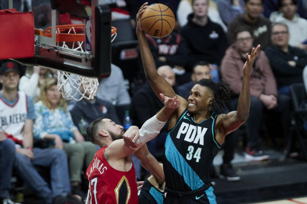 Portland Trail Blazers forward Jabari Walker, right, rebounds the ball over New Orleans Pelicans center Jonas Valanciunas during the second half of an NBA basketball game in Portland, Ore., Monday, March 27, 2023.