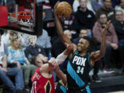 Portland Trail Blazers forward Jabari Walker, right, rebounds the ball over New Orleans Pelicans center Jonas Valanciunas during the second half of an NBA basketball game in Portland, Ore., Monday, March 27, 2023.