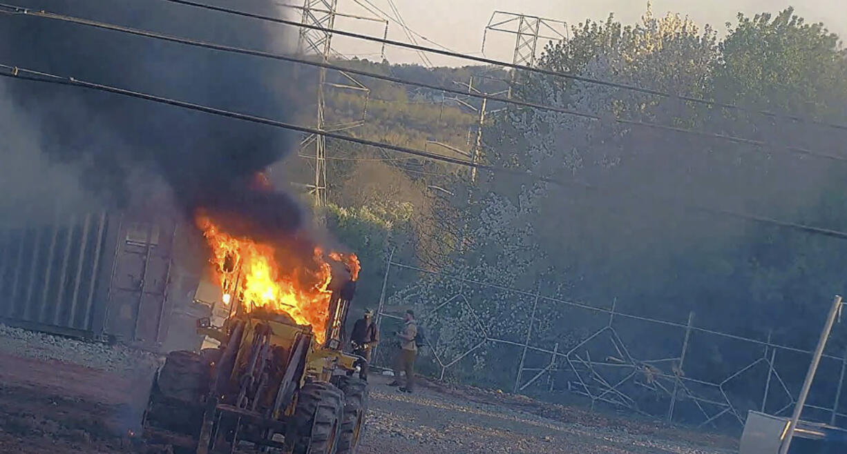 This image provided by the Atlanta Police Department shows construction equipment set on fire Saturday, March 4, 2023 by a group protesting the planned public safety training center, according to police.