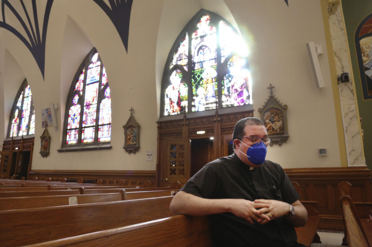 FILE - The Rev. Manuel Rodriguez sits in the pews of his church, Our Lady of Sorrows, on March 5, 2021, in the Queens borough of New York. A new survey by the Pew Research Center, Tuesday, March 28, 2023, says in-person attendance at religious services in the U.S. declined during the COVID-19 pandemic. But Rodriguez says attendance is now higher at his Catholic church than before the pandemic, even though more than 100 of his parishioners died of COVID.