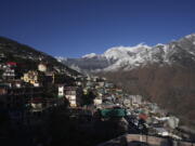 Joshimath town is seen along side snow capped mountains, in India's Himalayan mountain state of Uttarakhand, Jan. 21, 2023. For months, residents in Joshimath, a holy town burrowed high up in India's Himalayan mountains, have seen their homes slowly sink. They pleaded for help, but it never arrived. In January however, their town made national headlines. Big, deep cracks had emerged in over 860 homes, making them unlivable.