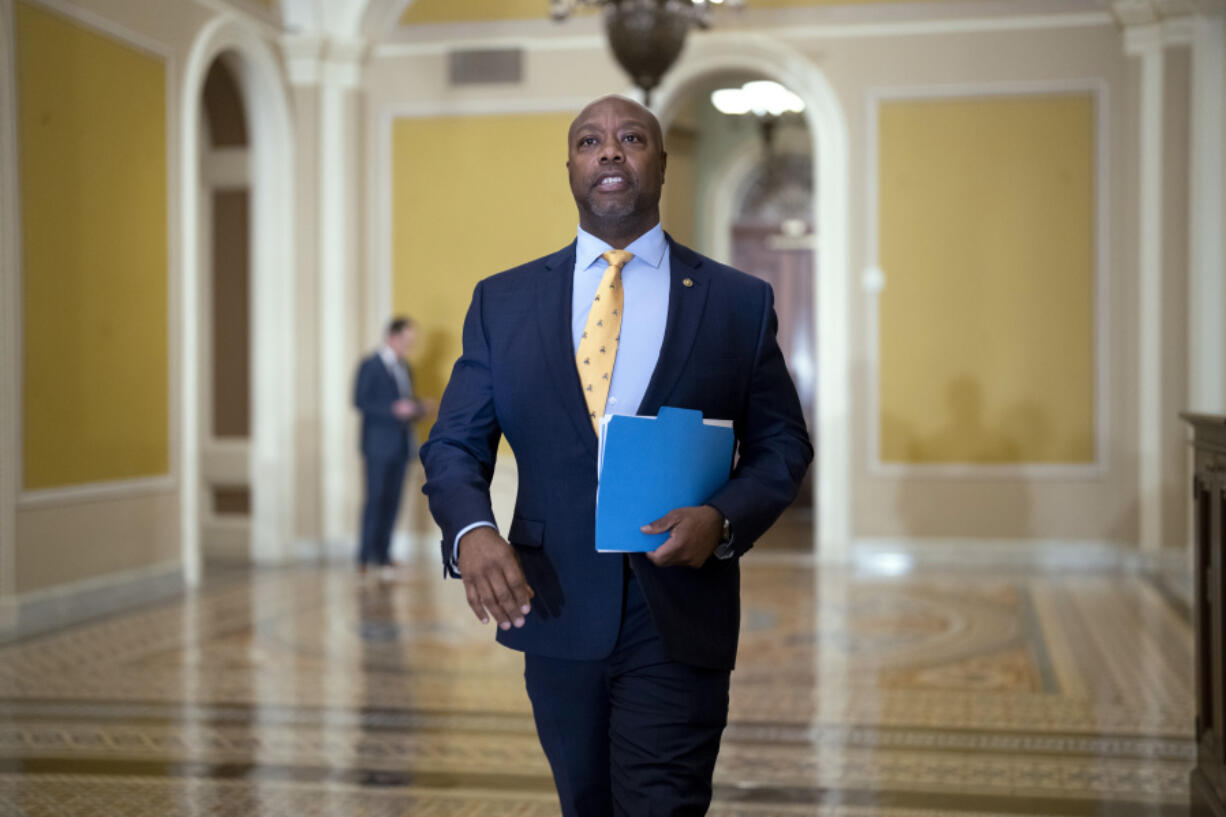 Sen. Tim Scott, R-S.C., walks past the chamber during the vote to confirm former Los Angeles Mayor Eric Garcetti as the next ambassador to India, more than a year and a half after he was initially selected for the post, at the Capitol in Washington, Wednesday, March 15, 2023. (AP Photo/J.