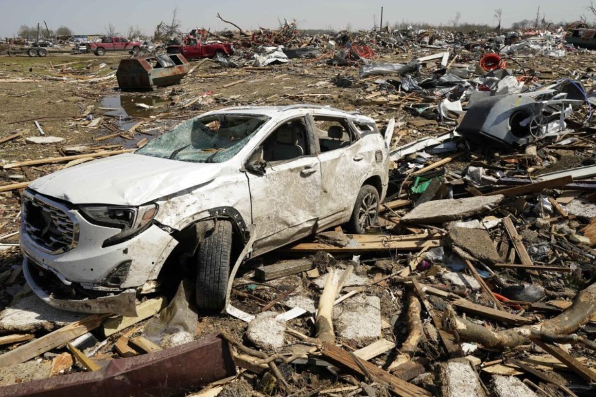 A vehicle awaits removal Saturday March 25, 2023, after getting destroyed by a Friday night tornado that hit Rolling Fork, Miss.  Emergency officials in Mississippi say several people have been killed by tornadoes that tore through the state on Friday night, destroying buildings and knocking out power as severe weather produced hail the size of golf balls moved through several southern states. (AP Photo/Rogelio V.