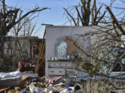 A chest of drawers and a mirror sit out in the open in the morning sunlight in Rolling Fork, Miss., Monday, March 27, 2023.