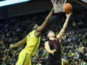 Oregon center N'Faly Dante (1) blocks the shot of Stanford guard Michael O'Connell (5) during the second half of an NCAA college basketball game Saturday, March 4, 2023, in Eugene, Ore.