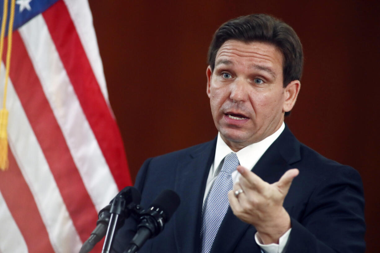 FILE - Florida Gov. Ron DeSantis answers questions from the media in the Florida Cabinet following his State of the State address during a joint session of the Senate and House of Representatives, Tuesday, March 7, 2023, at the state Capitol in Tallahassee, Fla. Texas and Florida are being led by tough-talking Republican governors weighing presidential runs as their state lawmakers debate especially strict legislation on border security.